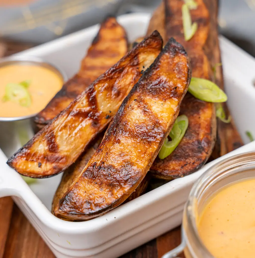 grilled potato wedges garnished with scallions