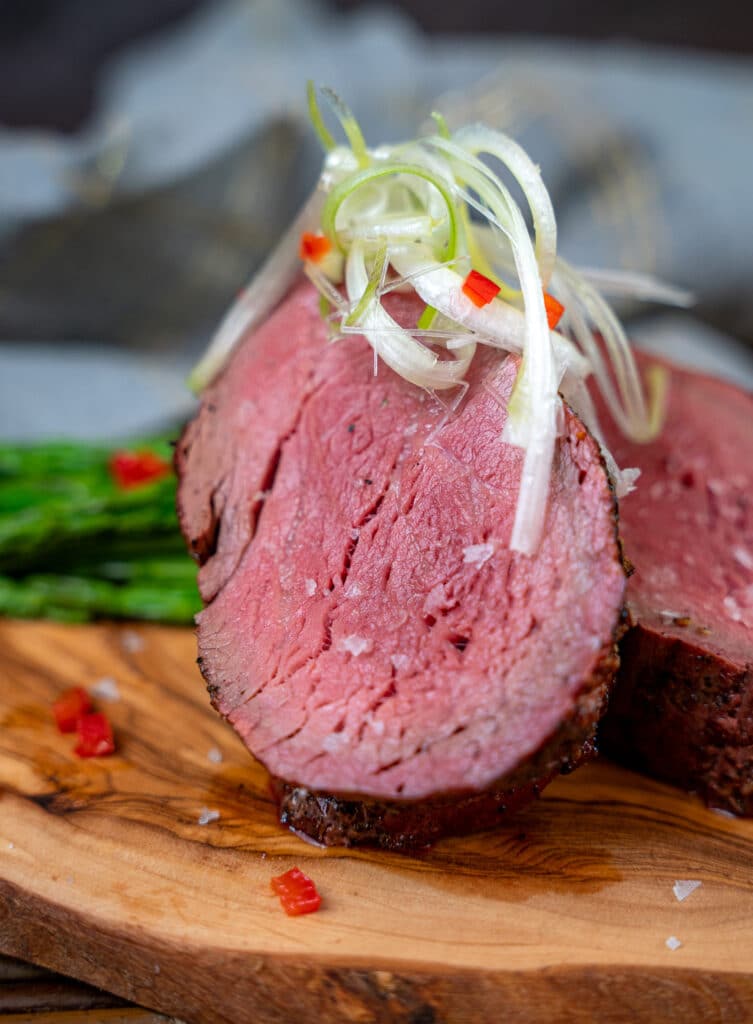 smoked beef tenderloin topped with sea salt and sliced scallions