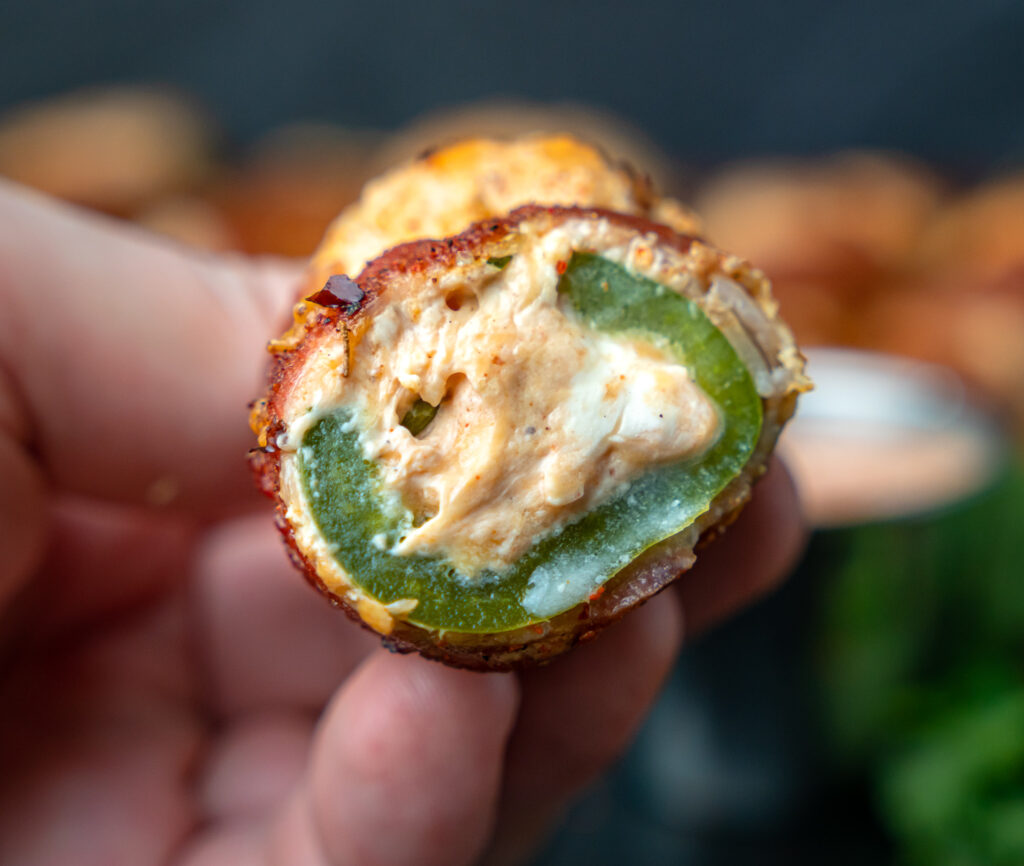 smoked stuffed jalapeño cut in half to show cheese filling