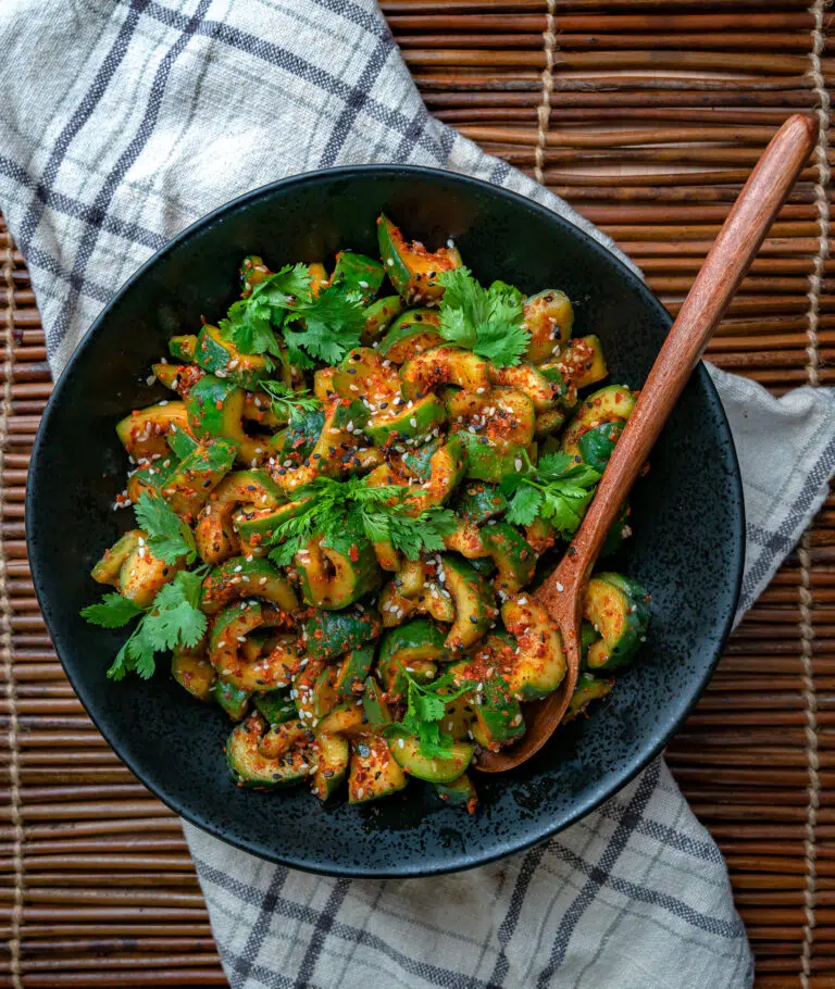 spicy Korean pickles in a bowl with wooden spoon