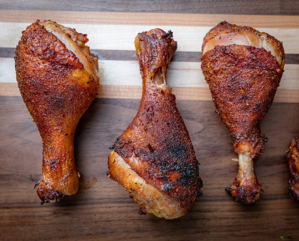 smoked chicken legs on a cutting board