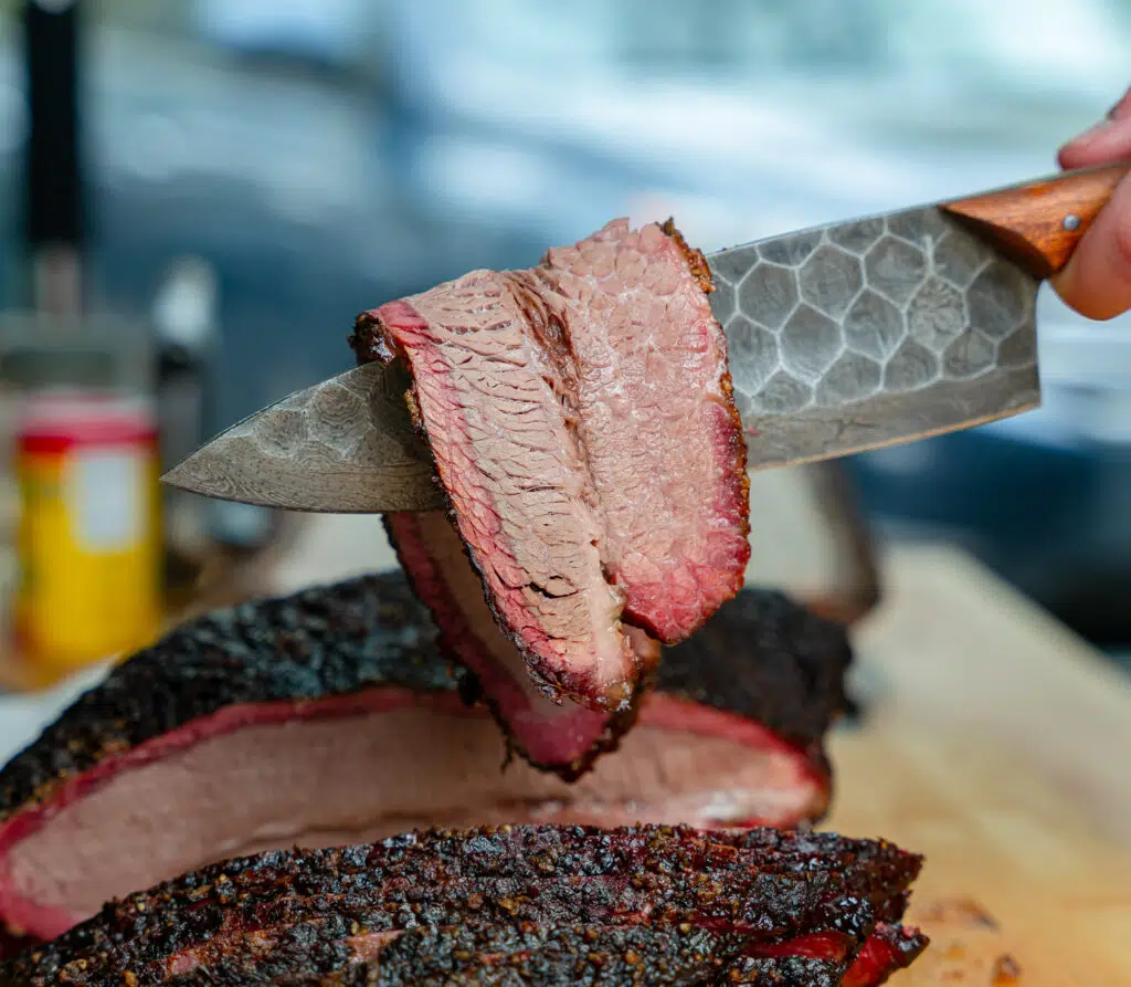 draping the perfect slice of brisket over a chefs knife