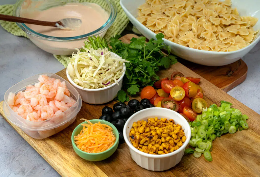pasta salad ingredients on a cutting board