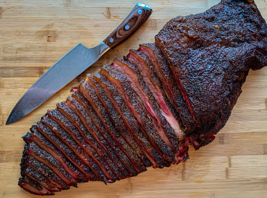 Sliced brisket on a wood cutting board