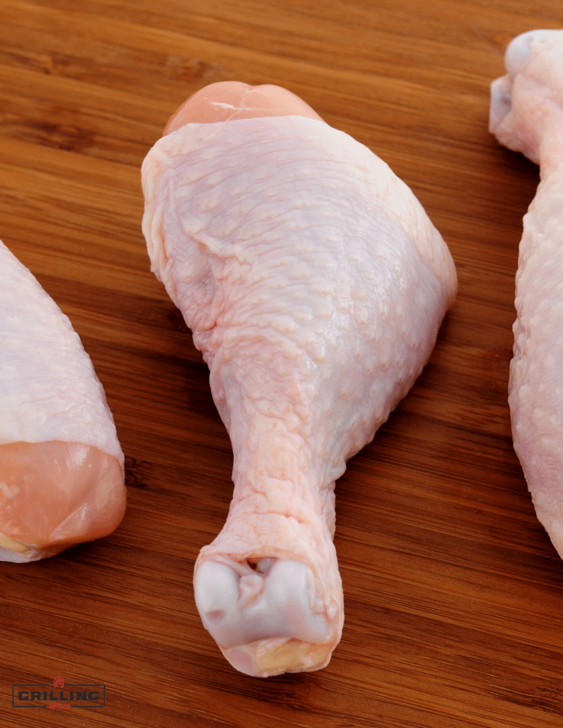 raw chicken legs being prepped for smoking