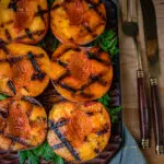 grilled peaches on a wooden tray with beautiful grill marks
