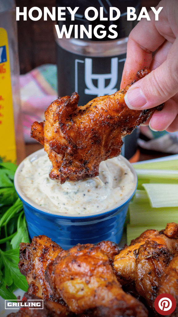 dipping a honey old bay wings in ranch dressing