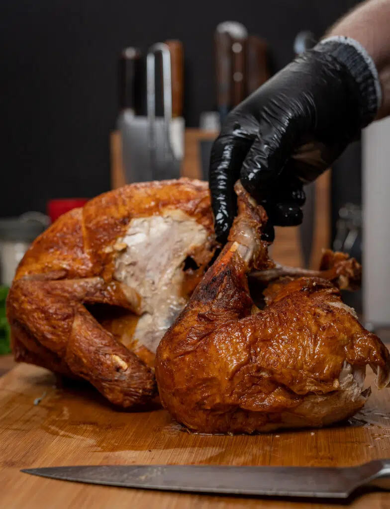 removing the leg quarter from the fried turkey