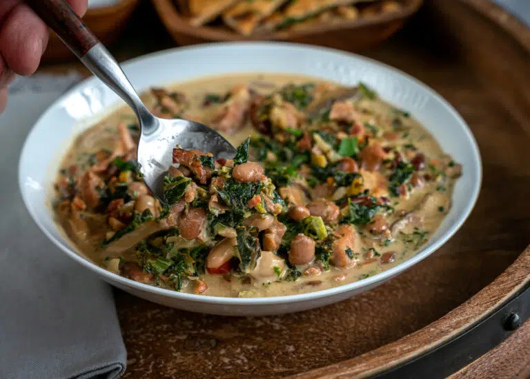 dipping spoon into ham and bean soup