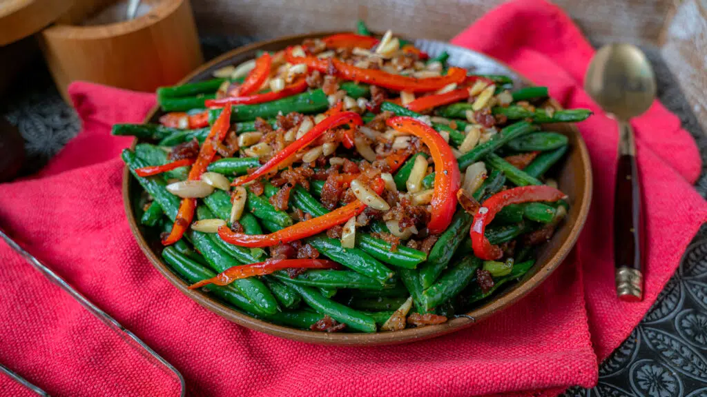 bowl of green beans with red pepper slices