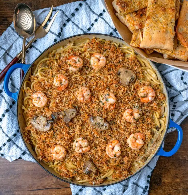 Shrimp tetrazzini in a large pan topped with breadcrumbs and mushrooms