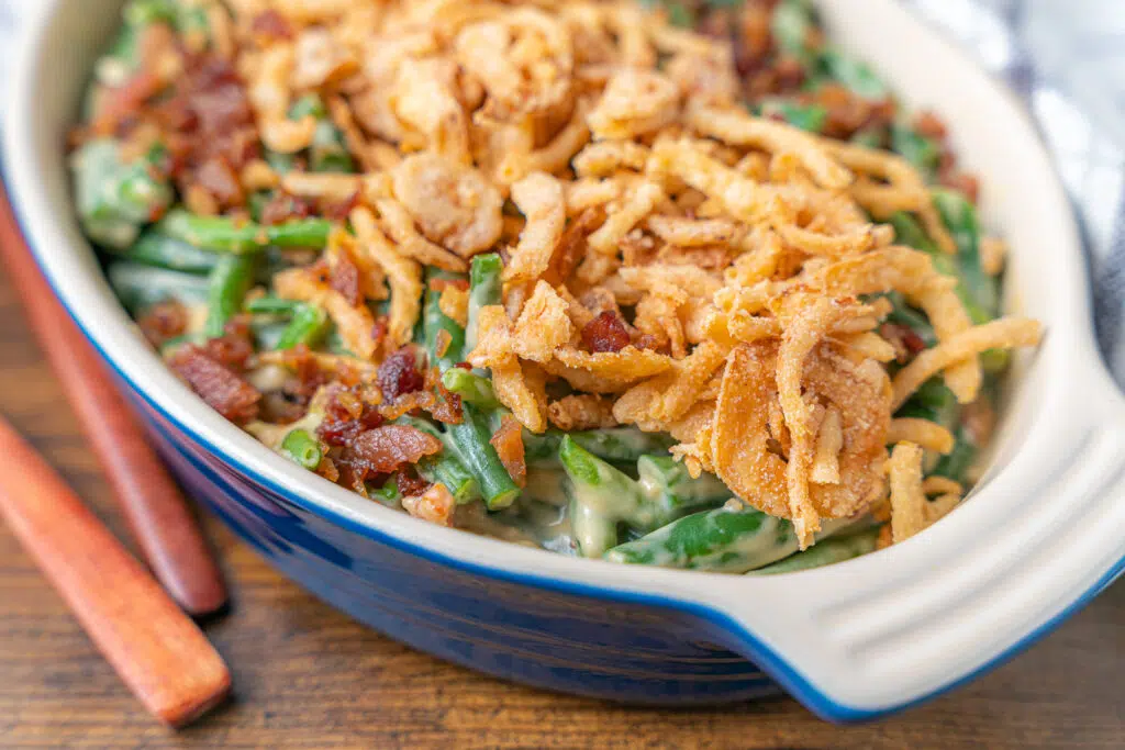 green bean casserole with no mushrooms tiopped with bacon and crispy onions