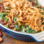 green bean casserole with no mushrooms tiopped with bacon and crispy onions