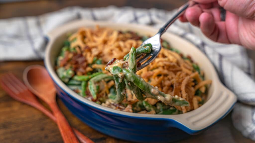 using a fork to scoop green bean casserole with no mushrooms