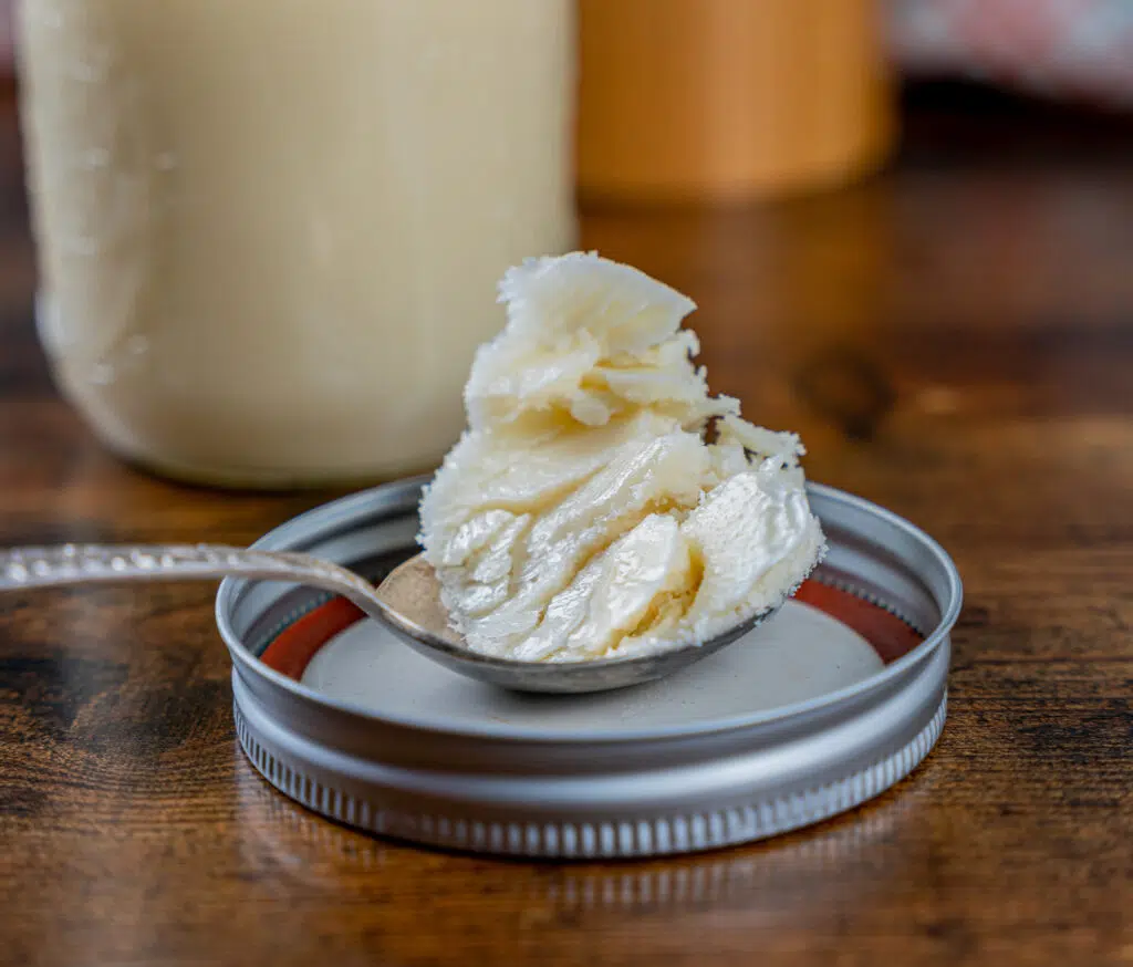 beef tallow on a spoon resting on a lid