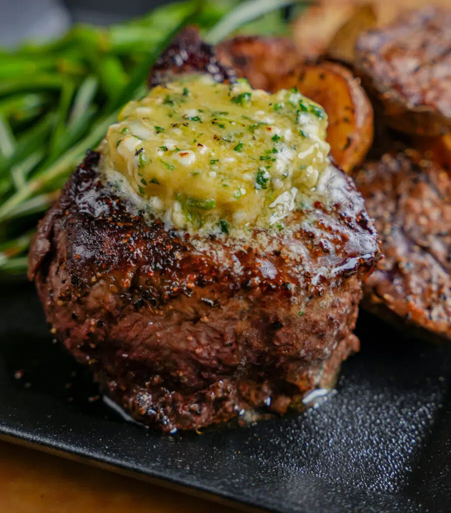 melted blue cheese compound butter on a steak