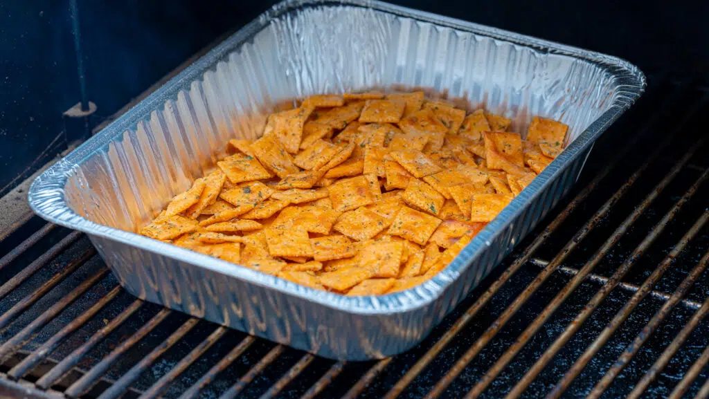 foil pan on the smoker with cheez its