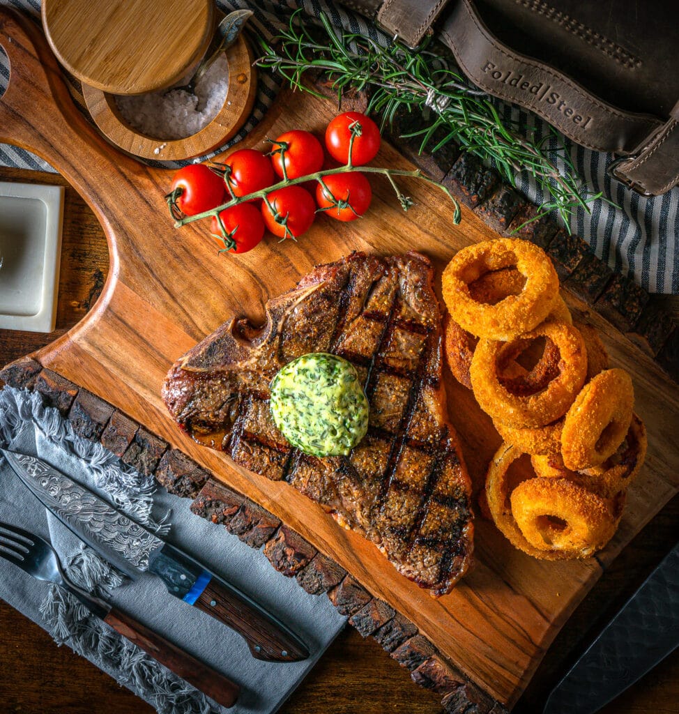 t bone steak with compound butter and onion rings
