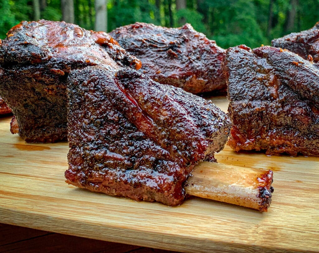 smoked beef ribs on a wood board