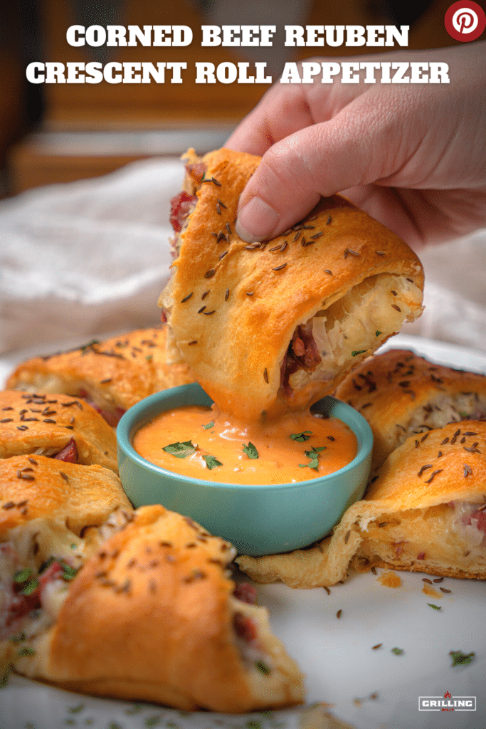 Corned Beef Reuben Crescent Roll Appetizer dipping into thousand island dressing
