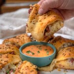 dipping Reuben Crescent Roll into thousand island dressing