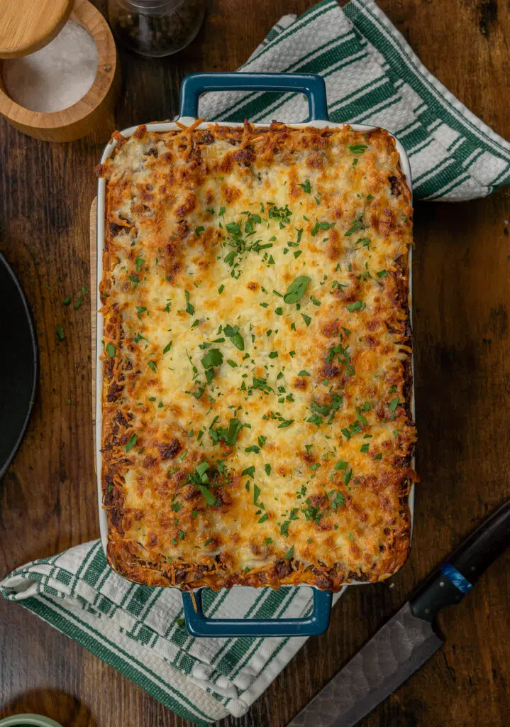 baked lasagna in a blue casserole dish