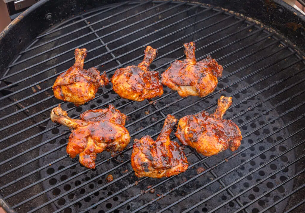 smoked chicken legs butterflied on the grill