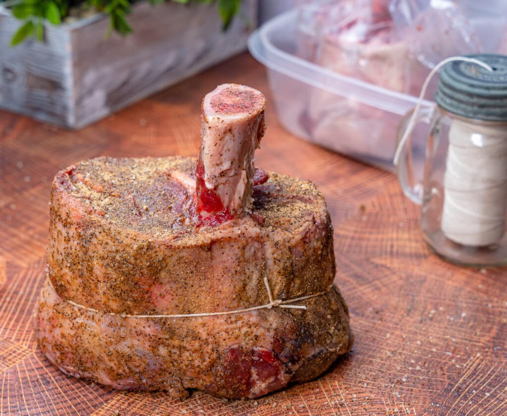 raw beef shank on a cutting board with butchers twine