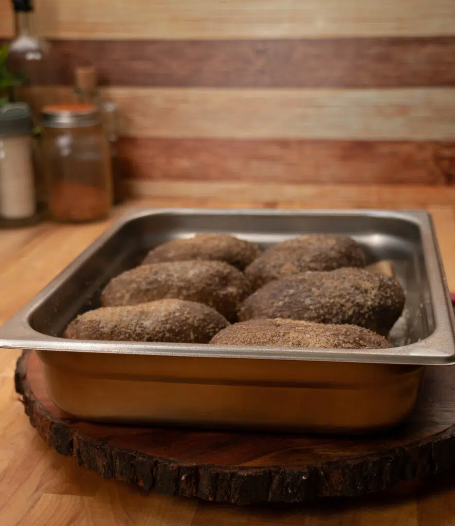 tray of smoked baked potatoes covered in kosher salt