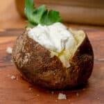 smoked baked potato with butter and sour cream