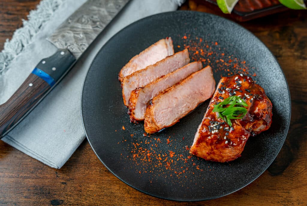 black plate with sliced boneless pork chops