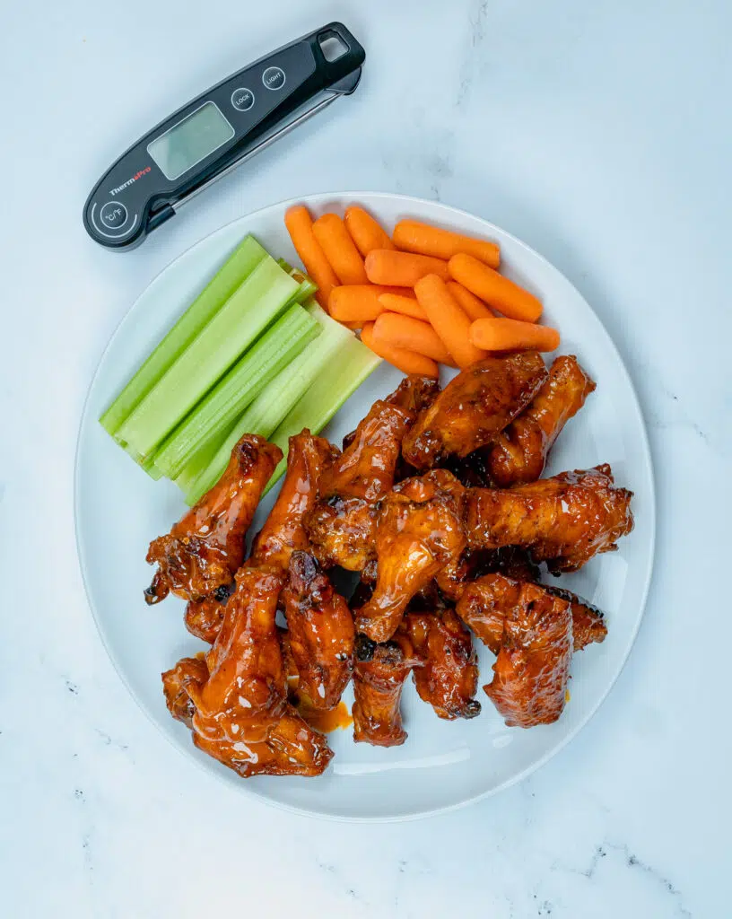 overhead picture of a plate of wings with celery and carrots