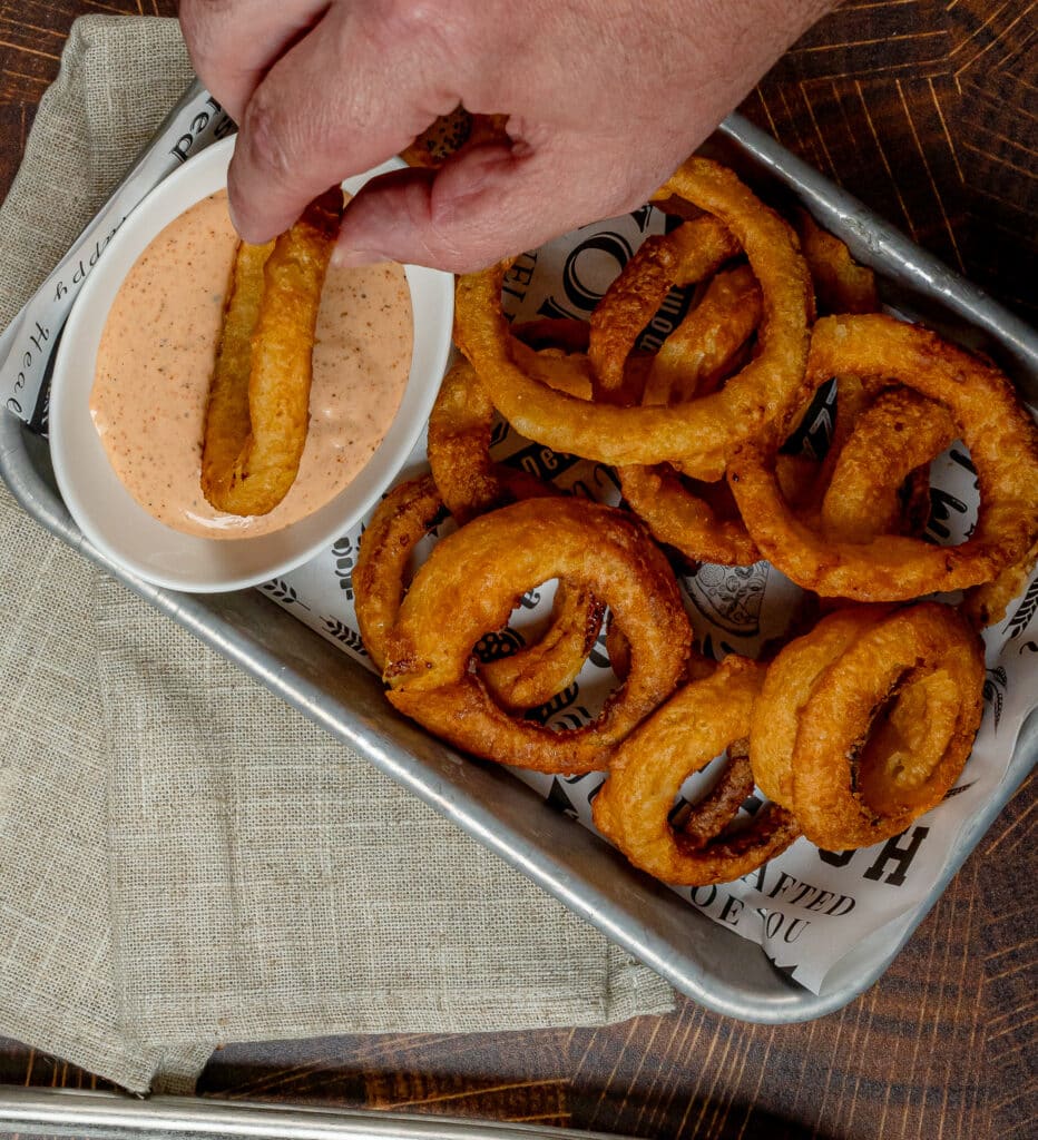 tray of onion rings with zesty onion ring sauce