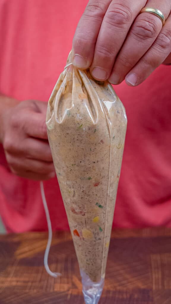 piping bag filled with ground beef cheese and veggies