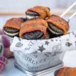 bacon wrapped Oreos in a basket with white deli paper