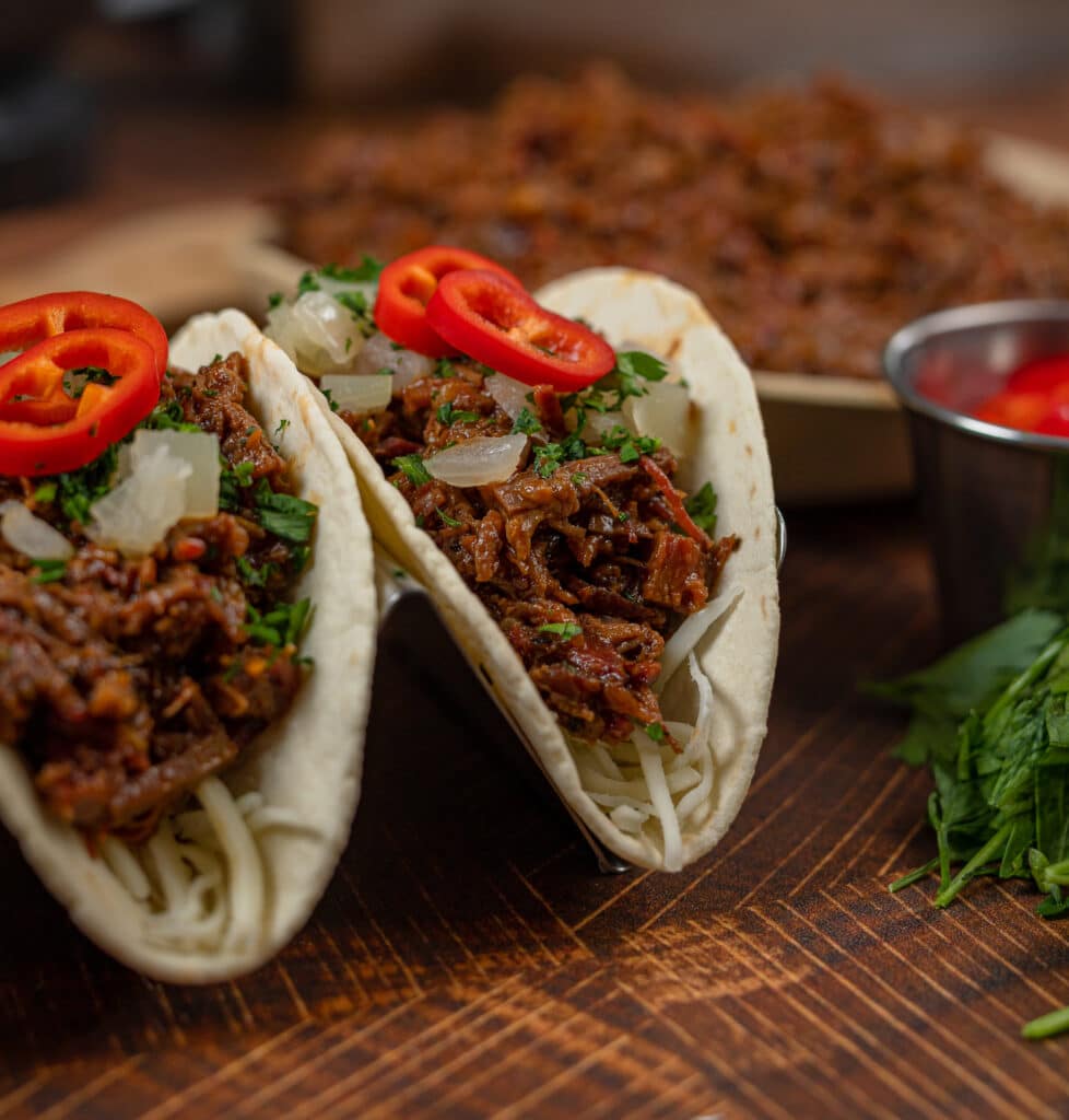 chopped beef tacos on a cutting board