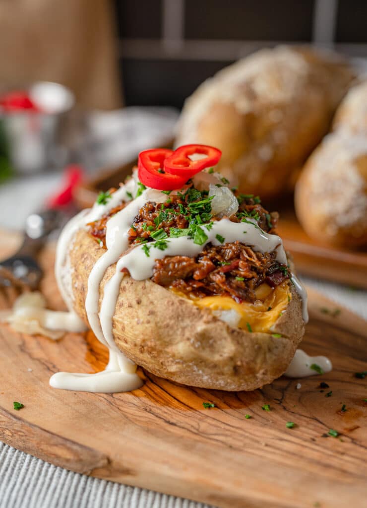 chopped beef baked potato with ranch cheese and sliced peppers 