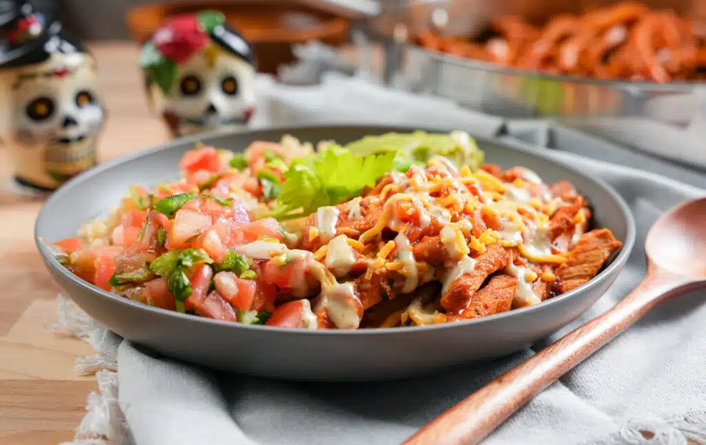 pork carnitas burrito bowl topped with pico de Gallo 