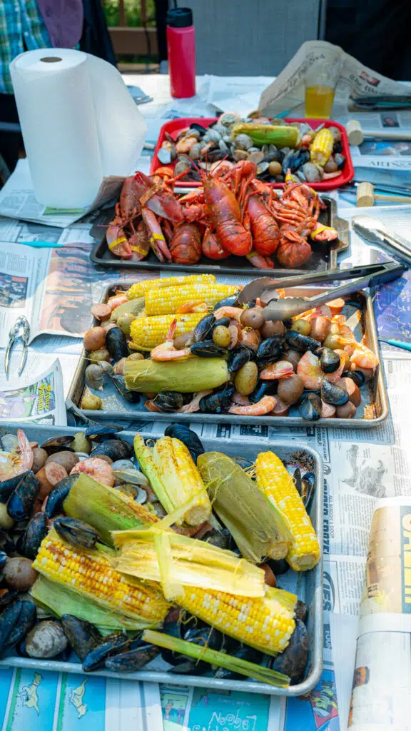 trays loaded with corn, potatoes and seafood