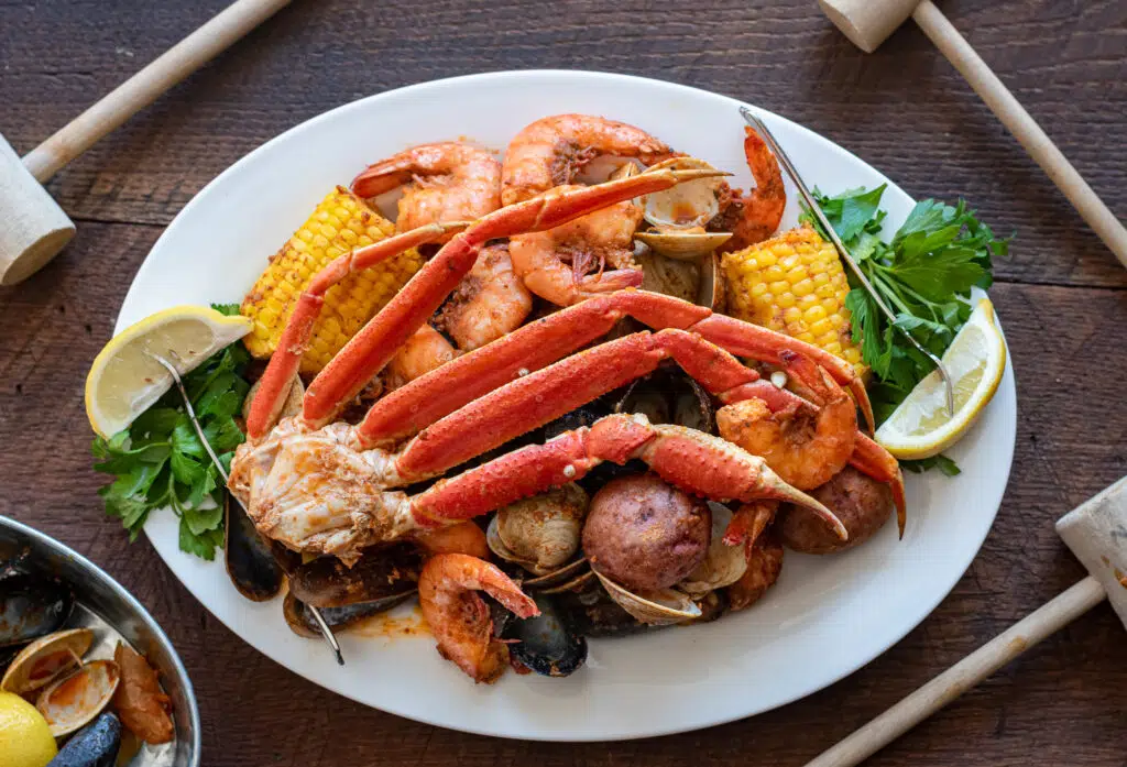 Platter loaded with snow crab, corn, mussels, shrimp and clams