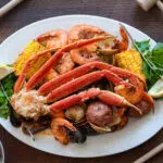 Platter loaded with snow crab, corn, mussels, shrimp and clams