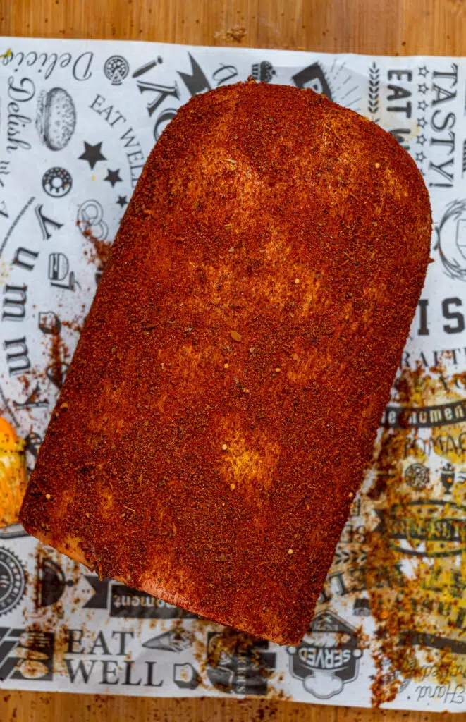 smoked bologna covered in bbq dry rub