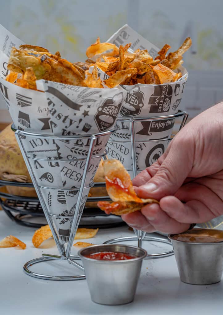 dipping potato peel chips in ketchup