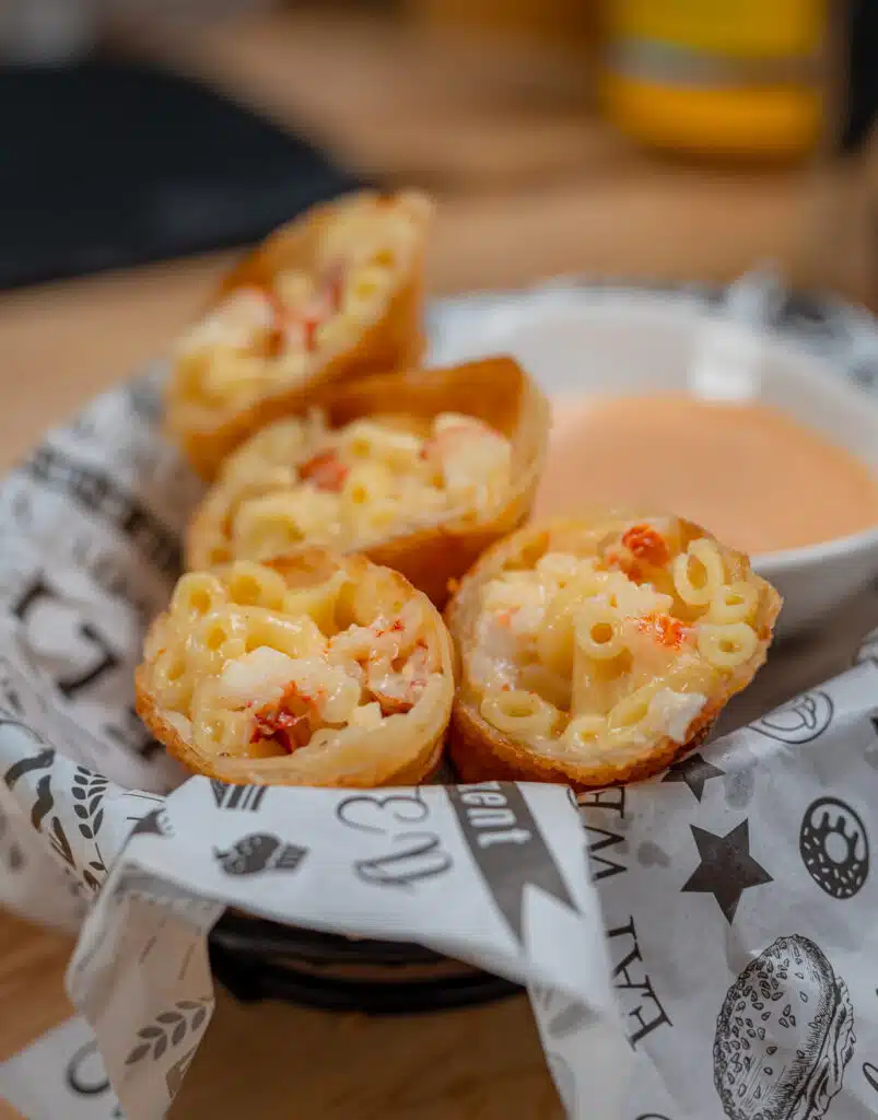 Basket full of lobster egg rolls with Mac and cheese