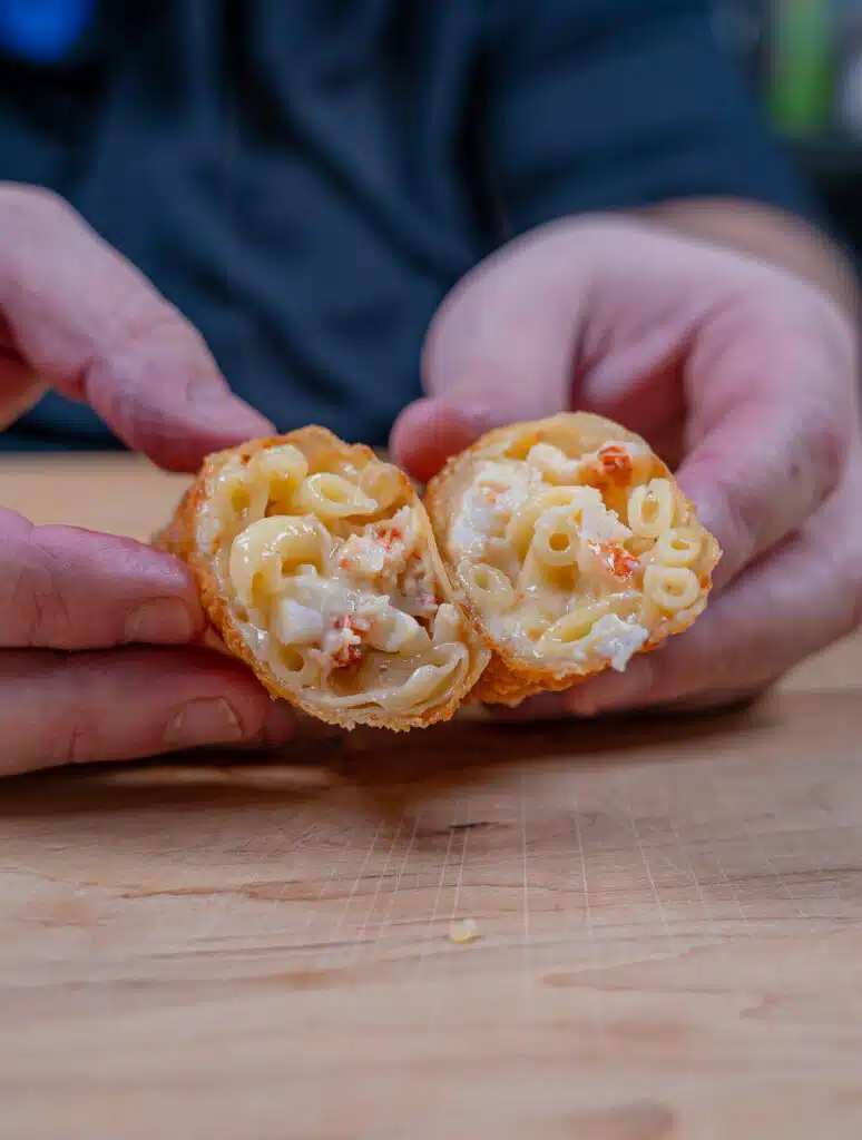 Lobster Mac and cheese egg roll cut in half to show the inside