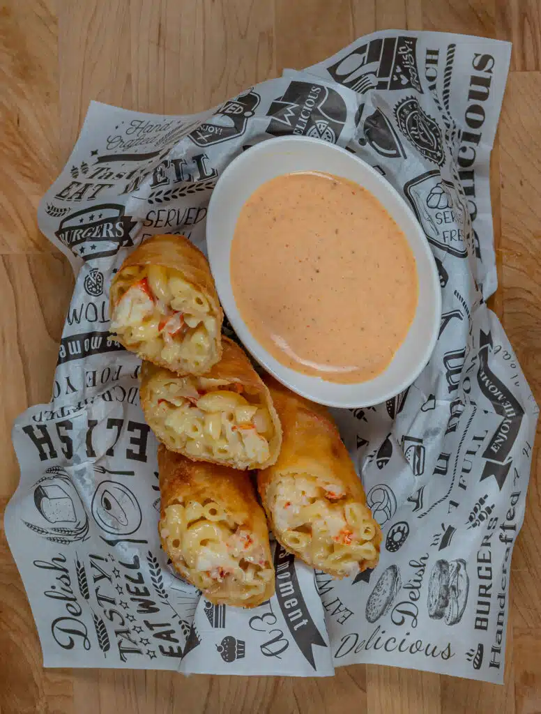 overhead shot of a basket with lobster Mac egg rolls