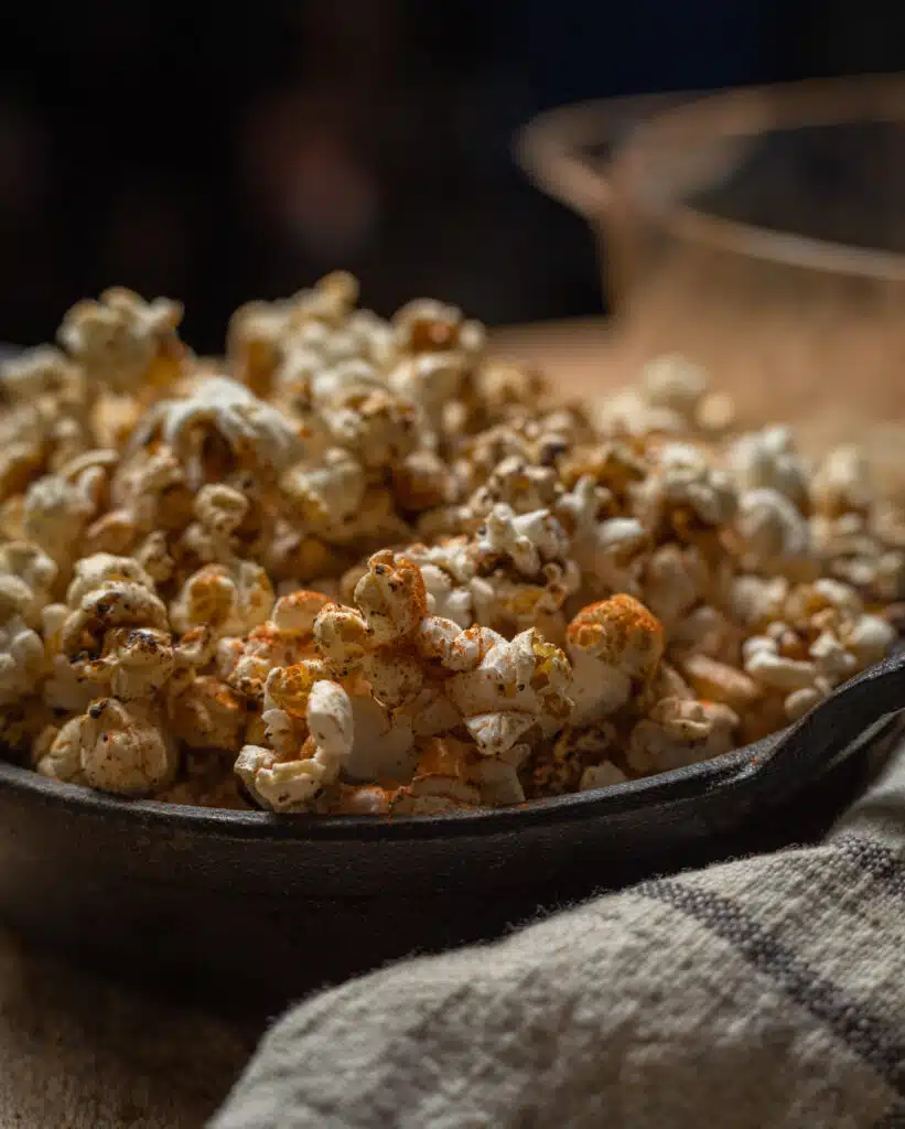 moody picture of smoked popcorn in a skillet
