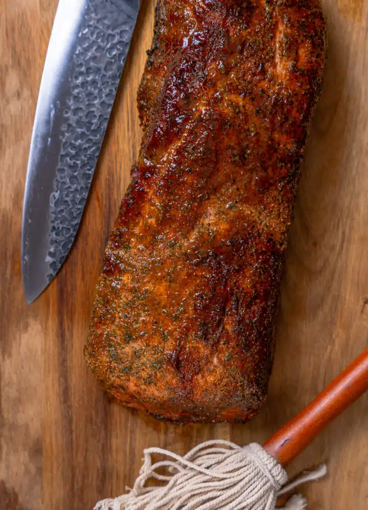 whole smoked pork loin on a cutting board
