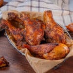 metal basket lined with deli paper filled with bbq chicken legs