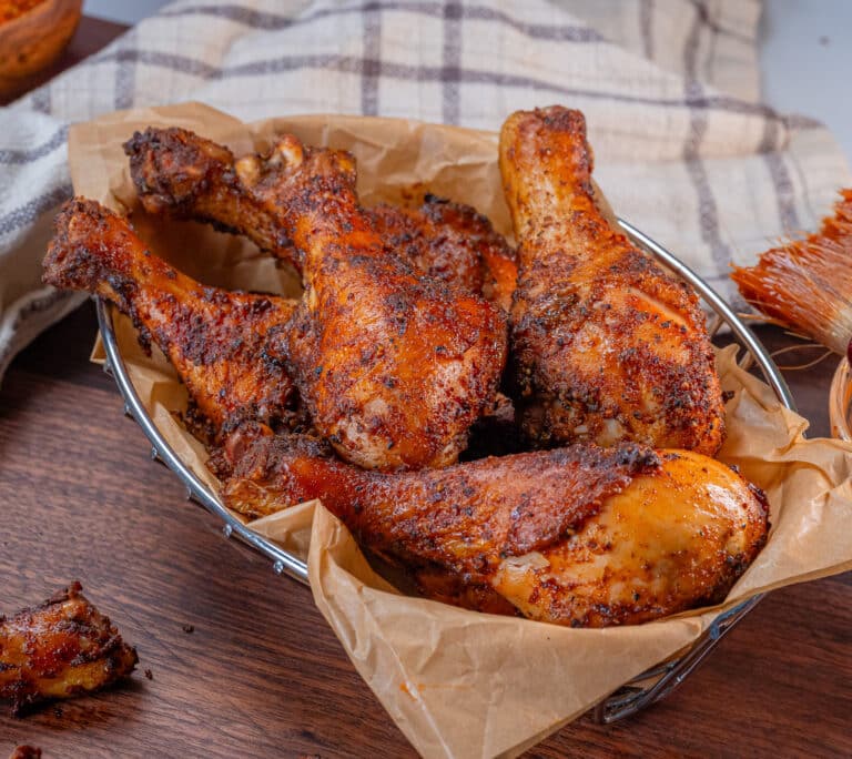 metal basket lined with deli paper filled with bbq chicken legs